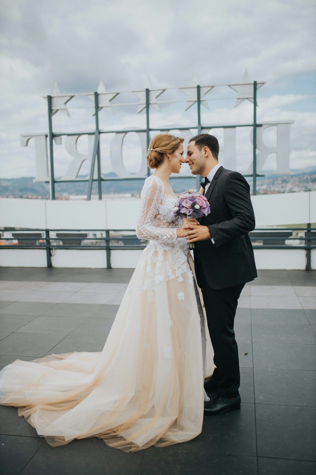 man and woman holding hands while walking on white floor tiles