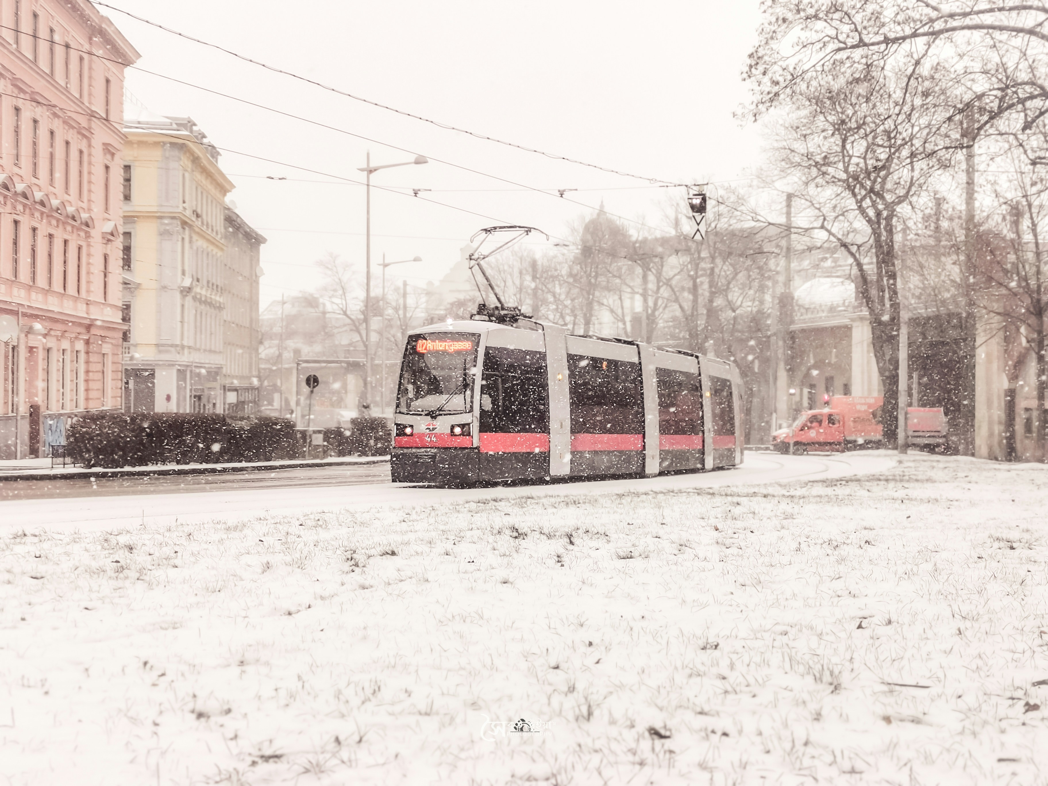 red and white train on snow covered road during daytime