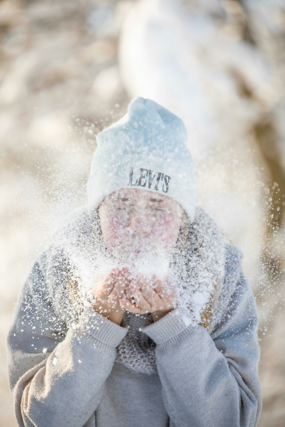 person in gray and white jacket covered with snow