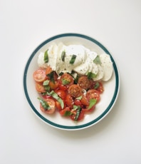 sliced strawberries on white ceramic bowl