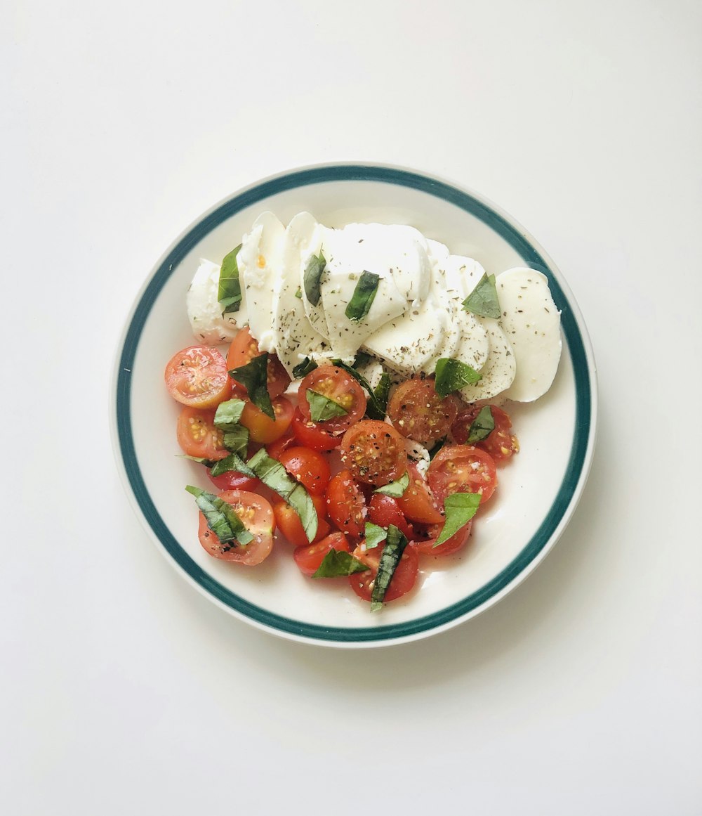 sliced strawberries on white ceramic bowl