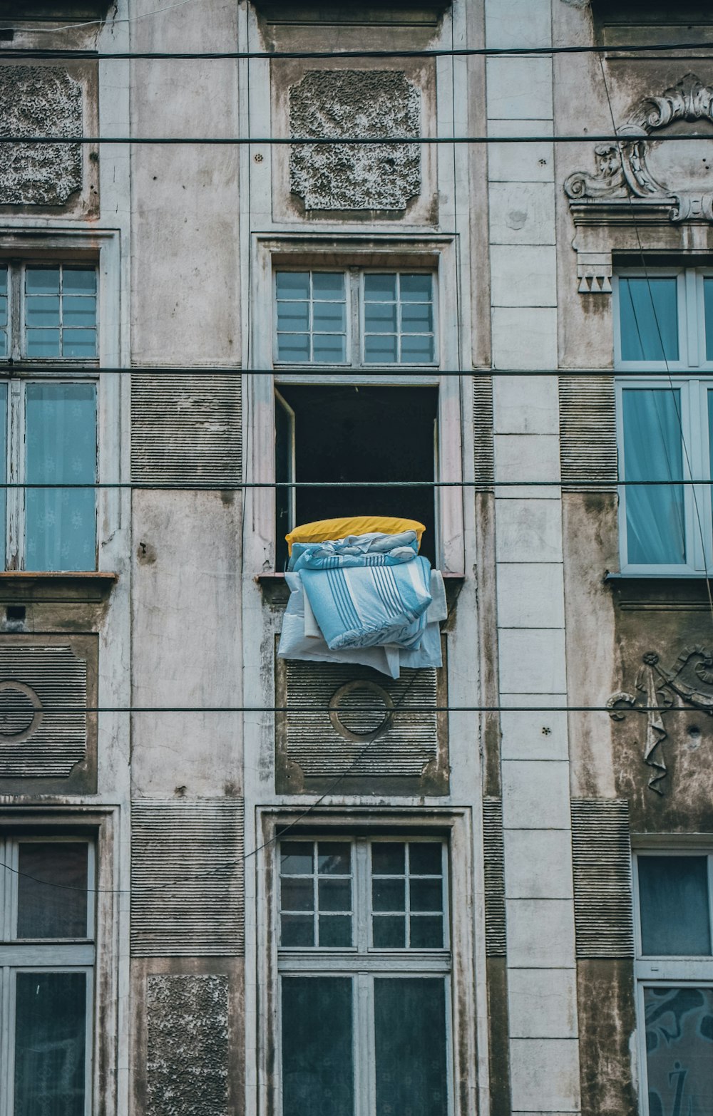 blue and yellow umbrella on window