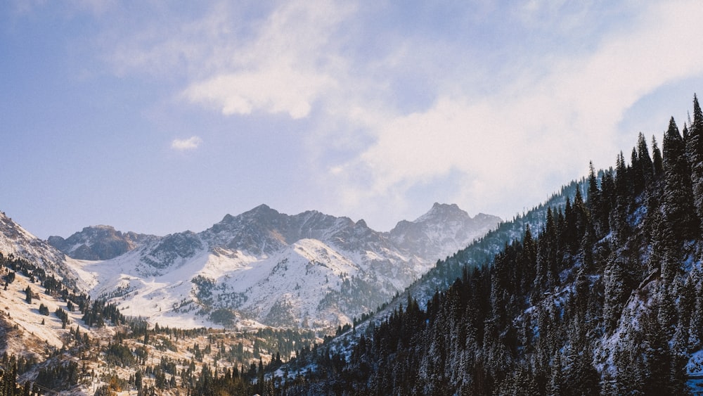 snow covered mountain under cloudy sky during daytime