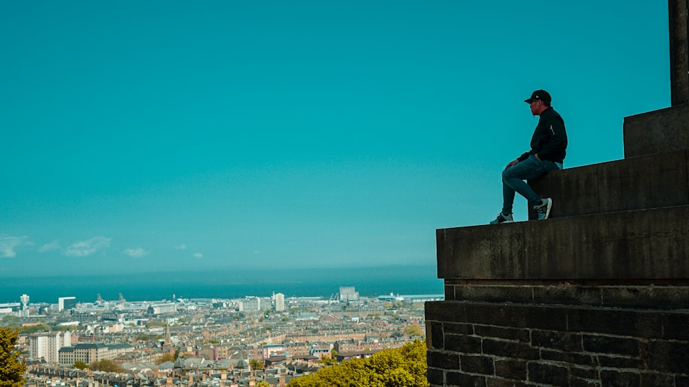 statue of man on top of building during daytime