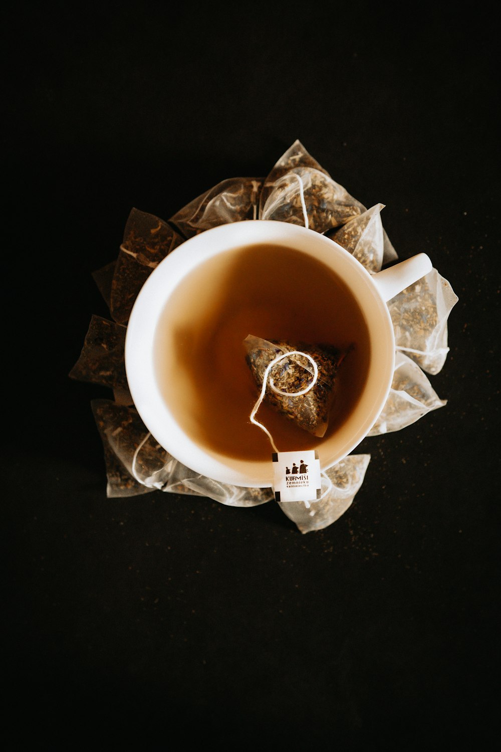 white ceramic mug with brown liquid inside