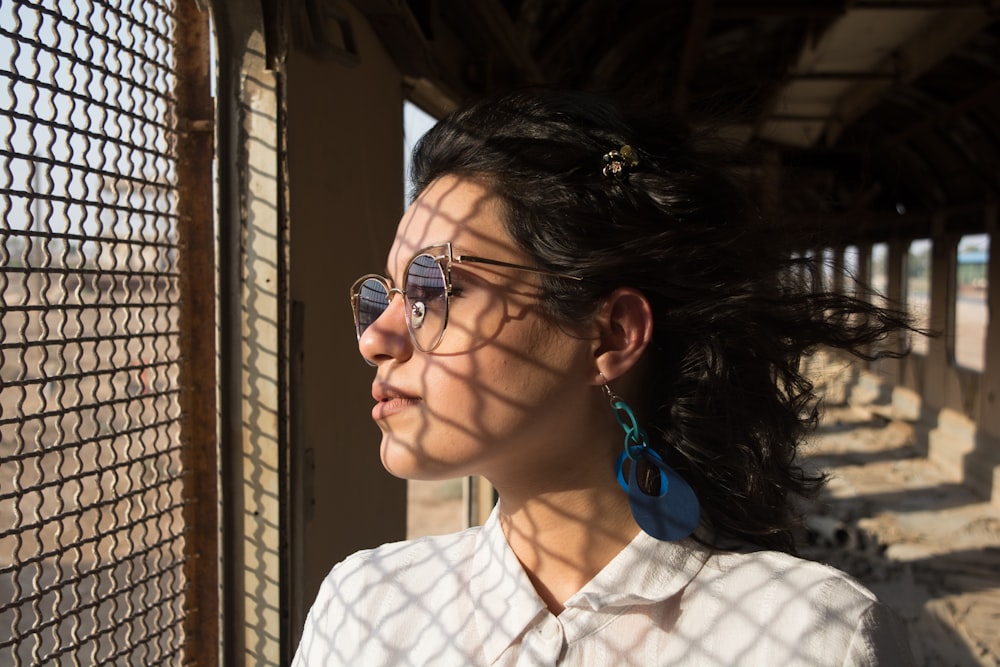 woman in white and black checkered button up shirt wearing eyeglasses