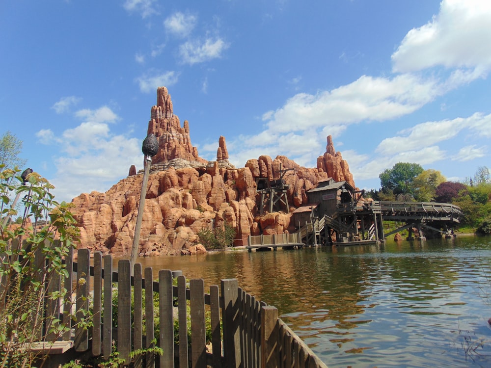 brown wooden fence near body of water during daytime