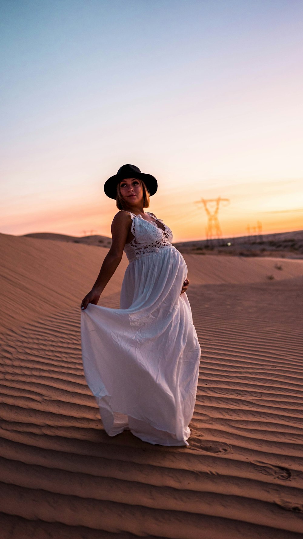 woman in white dress standing on beach during daytime