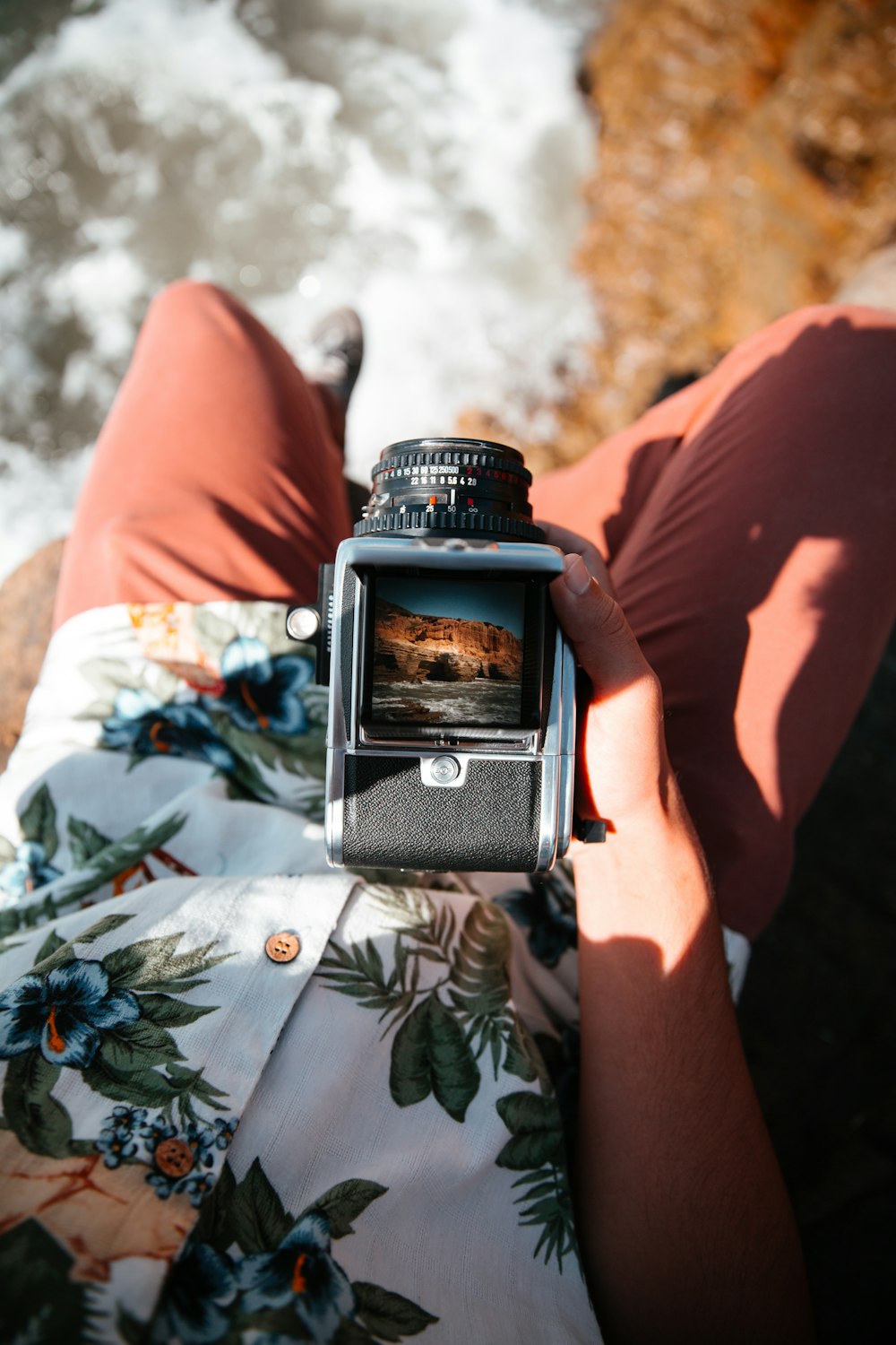 black and silver dslr camera on persons lap