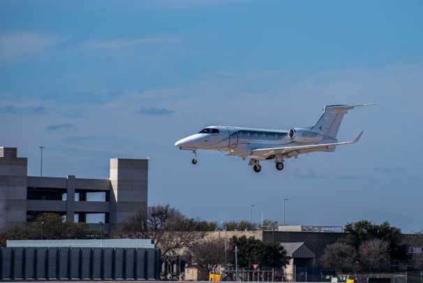 white and blue passenger plane in the sky during daytime