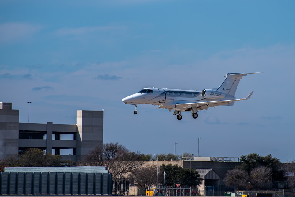 white and blue passenger plane in the sky during daytime