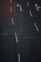 Wide shot of freshly paved asphalt road with clear markings.