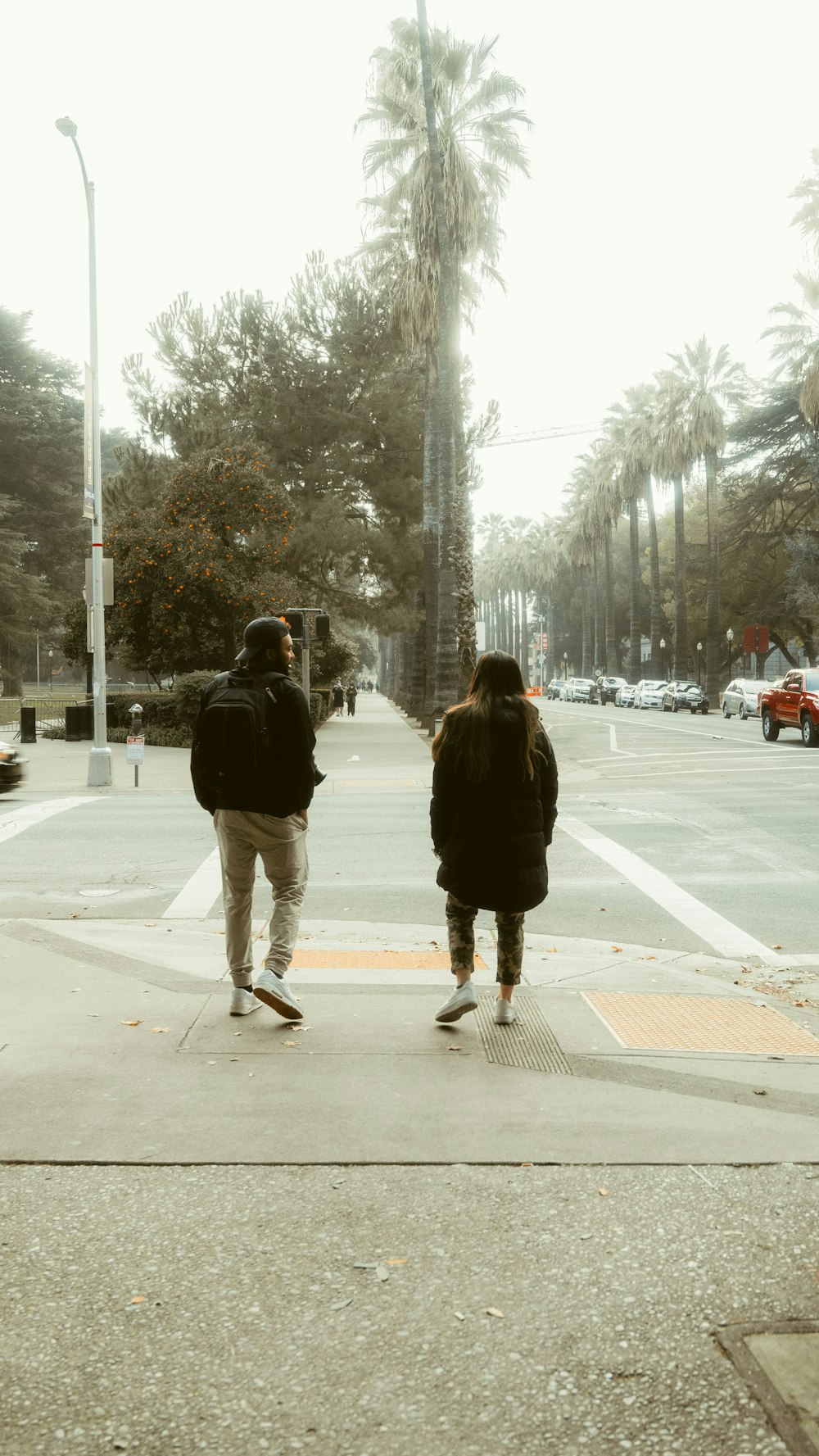 man and woman walking on street during daytime