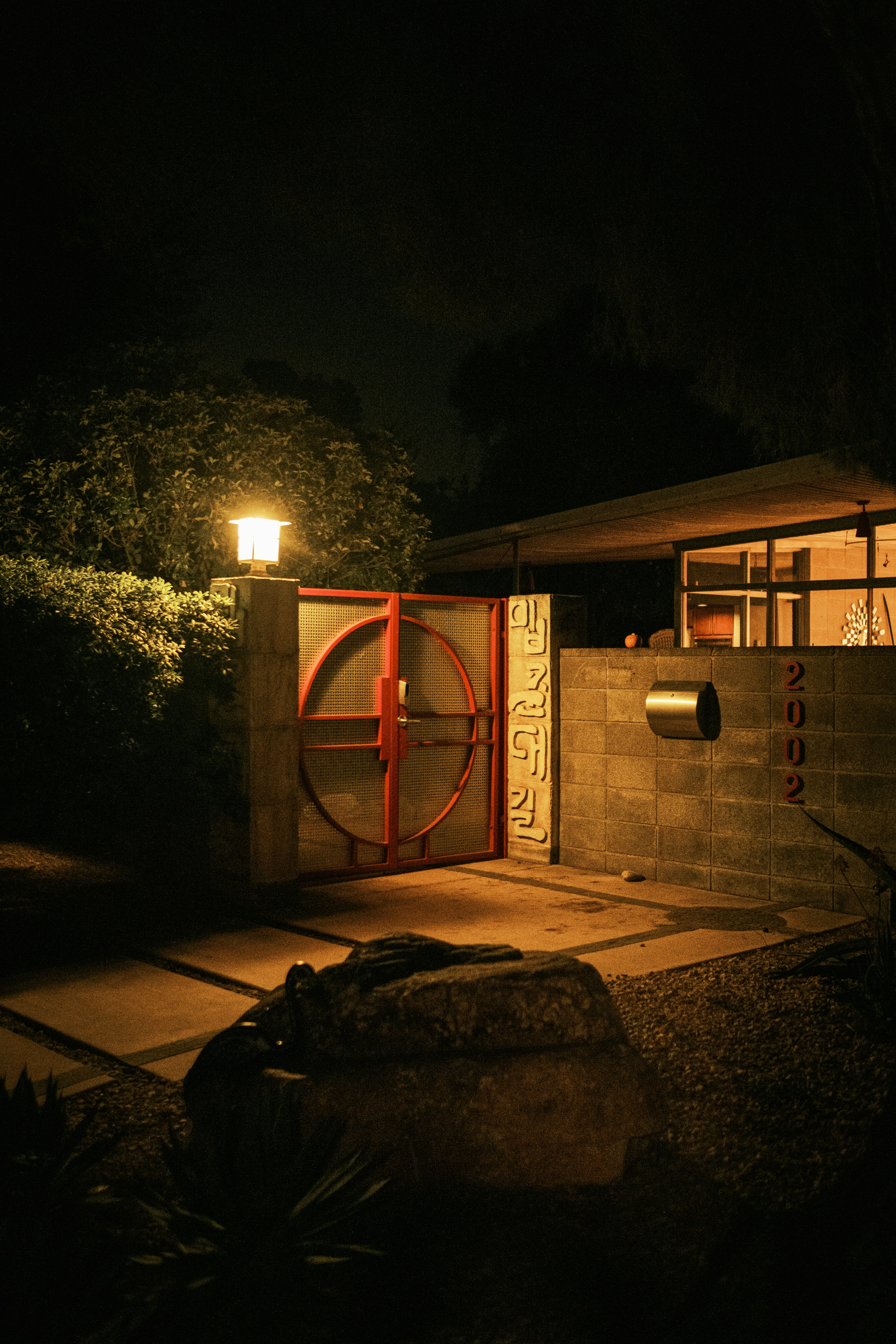 brown wooden house near trees during night time