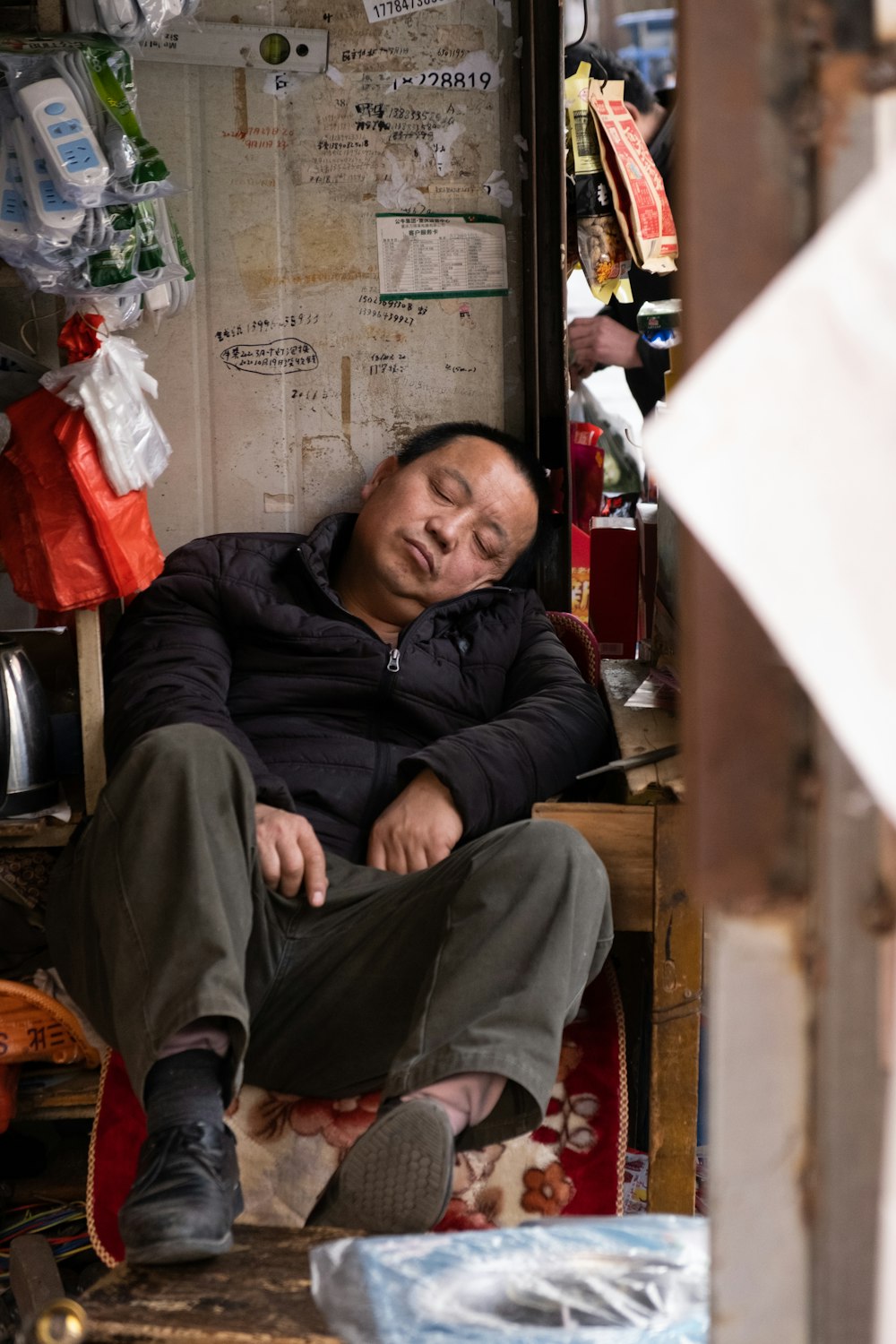 man in black jacket sitting on chair