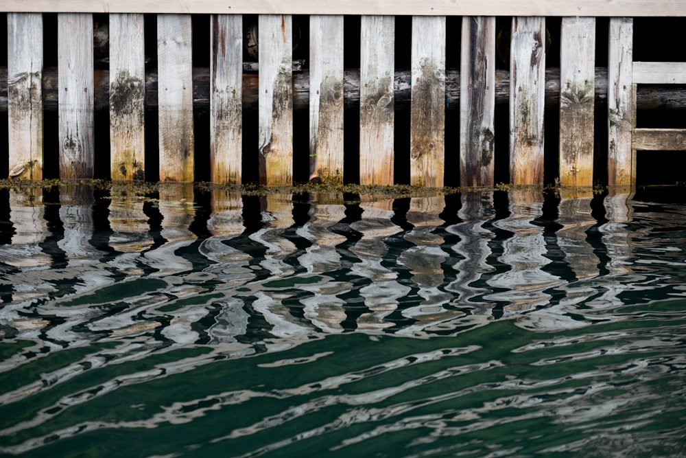 brown wooden fence on water