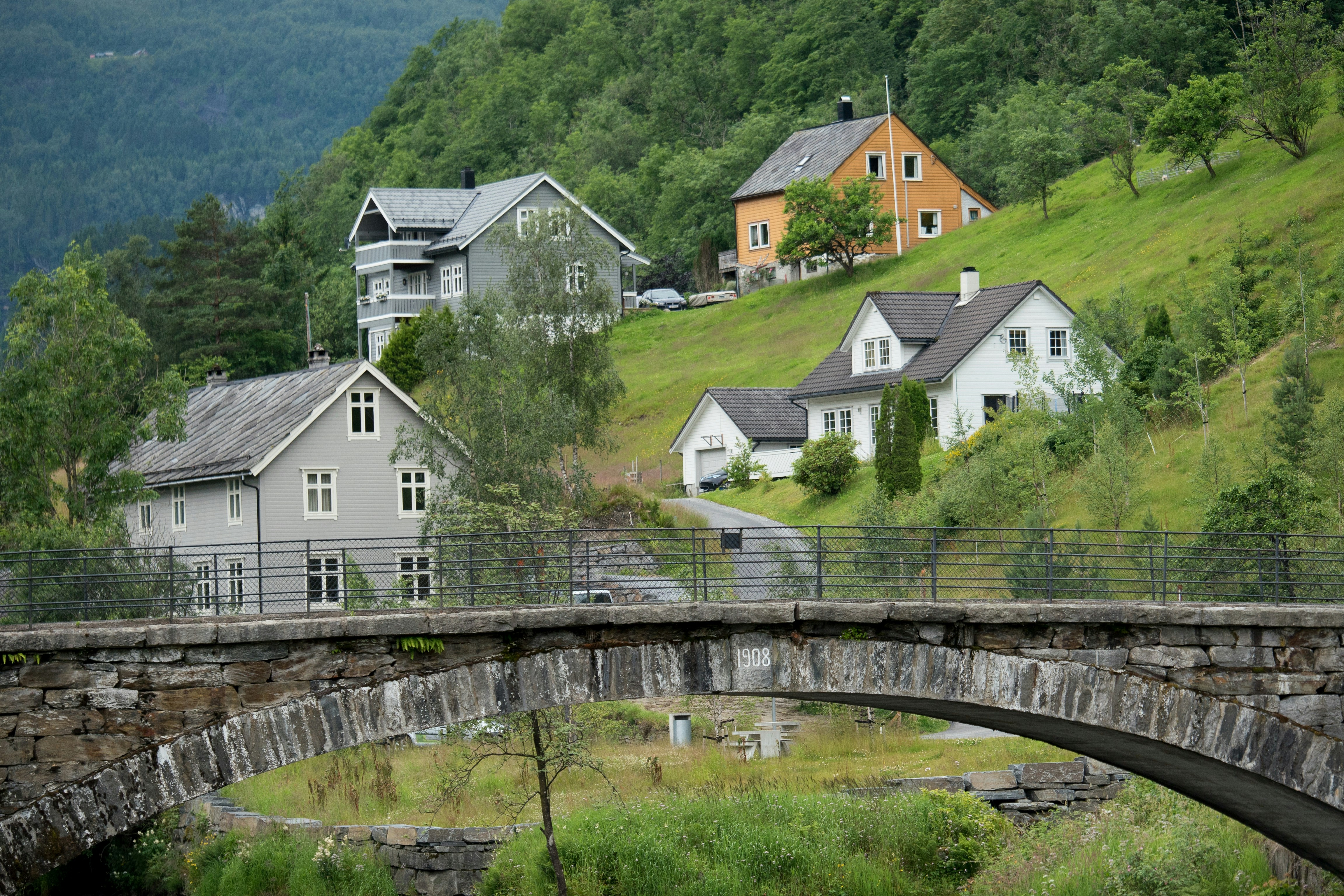 white and brown house near green grass field during daytime