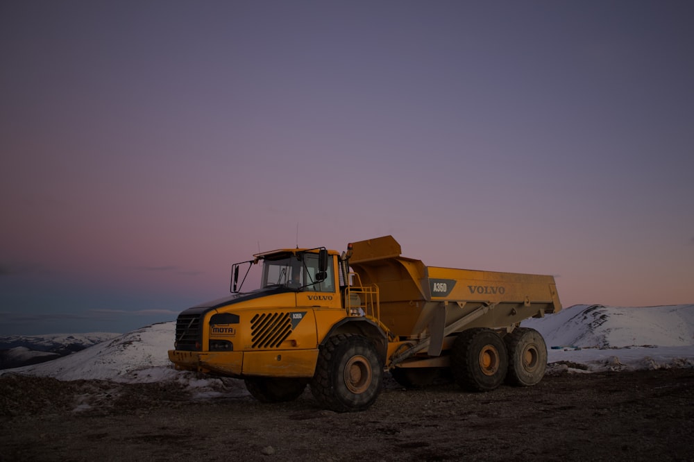 yellow and black heavy equipment on snow covered ground during daytime