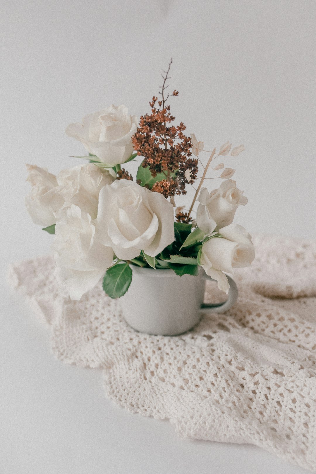 white and pink flowers in white ceramic vase