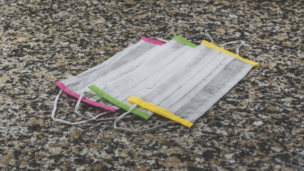 white and green textile on brown and black marble table