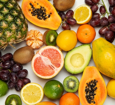 sliced orange fruit and green round fruits