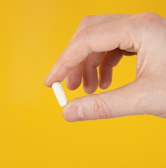 person holding white cigarette stick