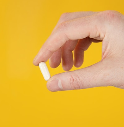 person holding white cigarette stick