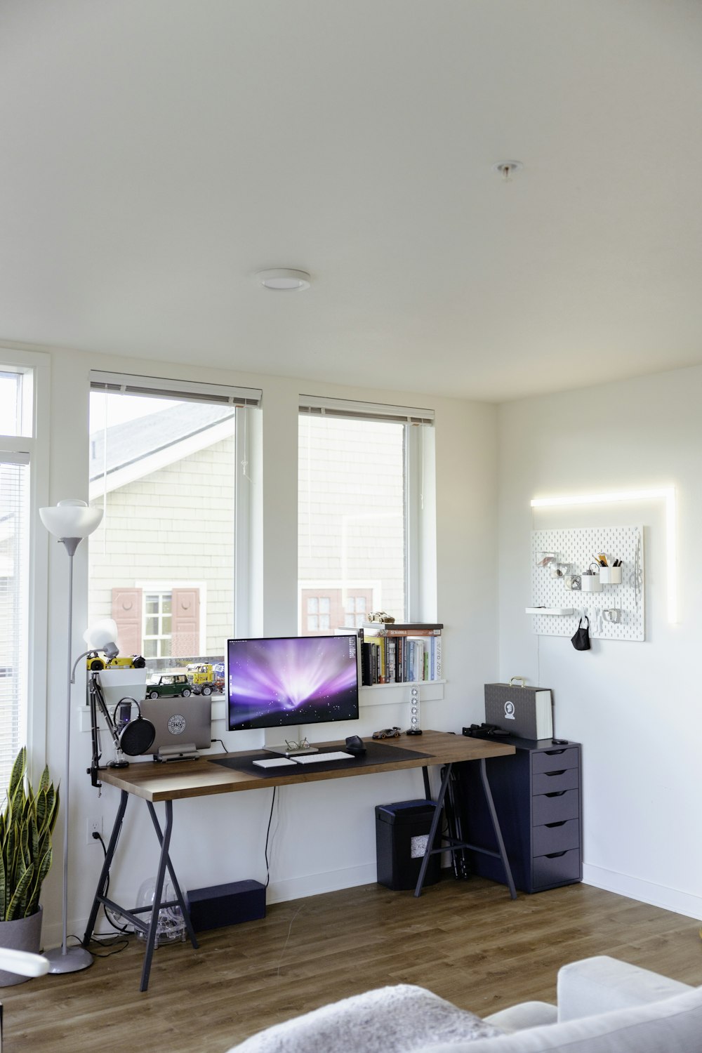 black flat screen computer monitor on brown wooden desk