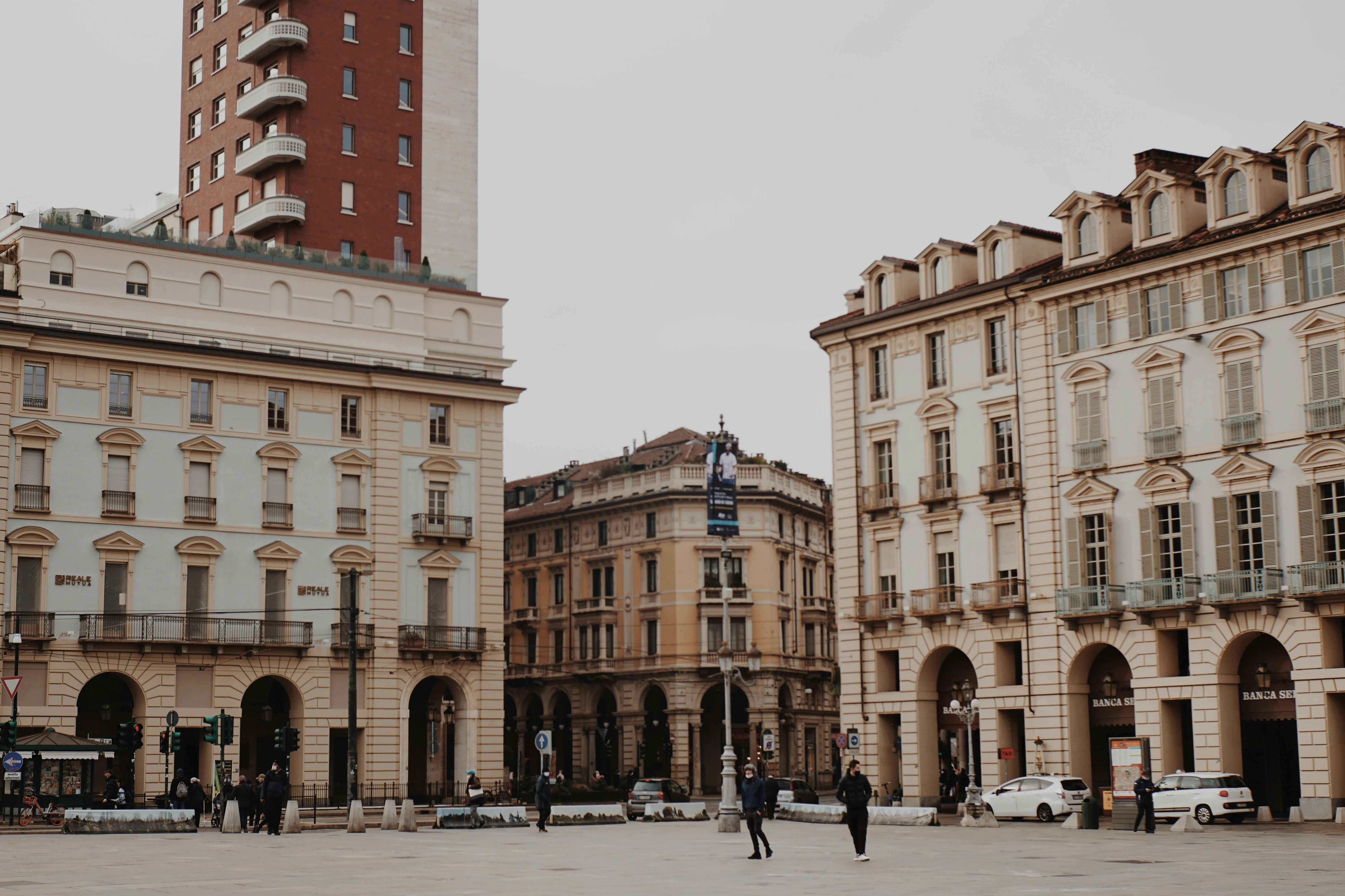 people walking on street near brown concrete building during daytime, Traditional Italian architecture 