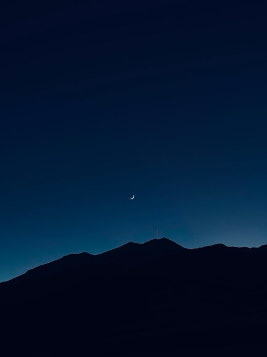 silhouette of mountain under blue sky during night time in Pirin National Park Bulgaria