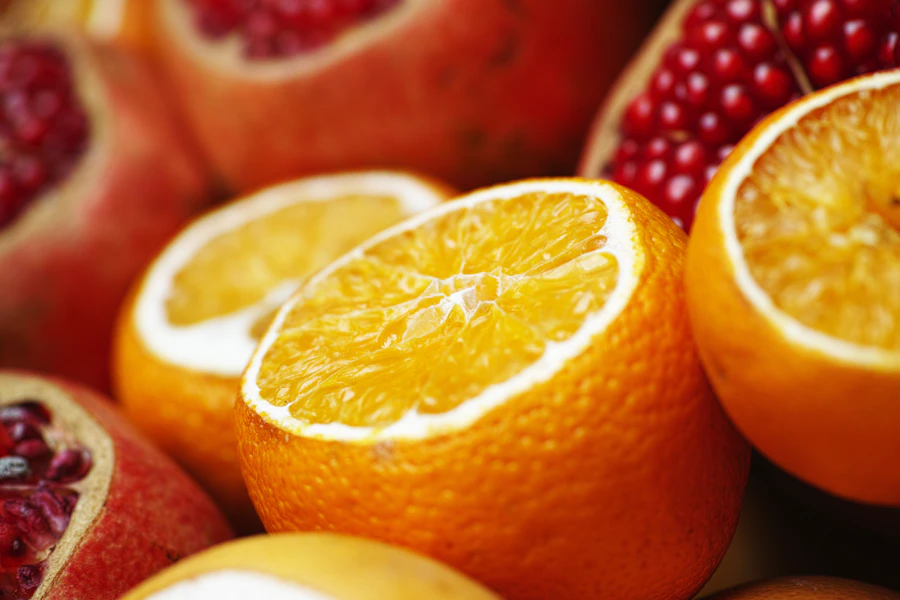 Sliced orange on white surface — vitamin C for collagen synthesis