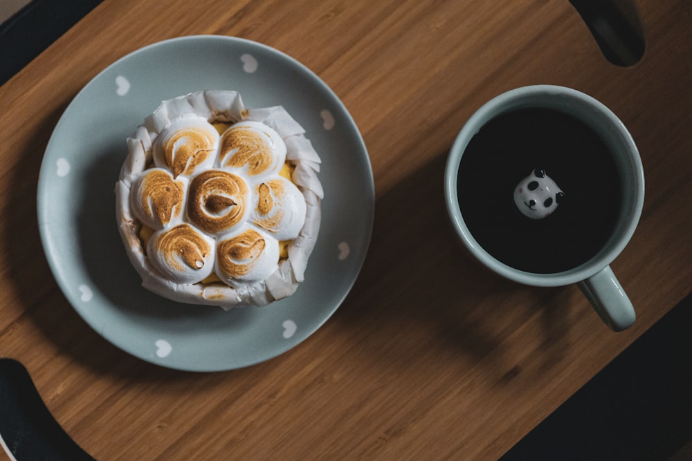 white and black ceramic bowl with brown and white liquid