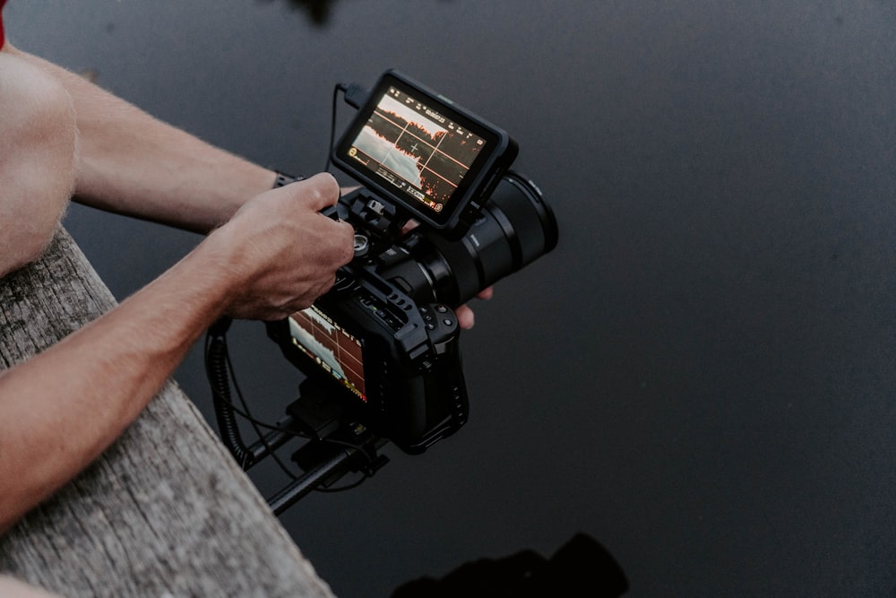 person holding black video camera