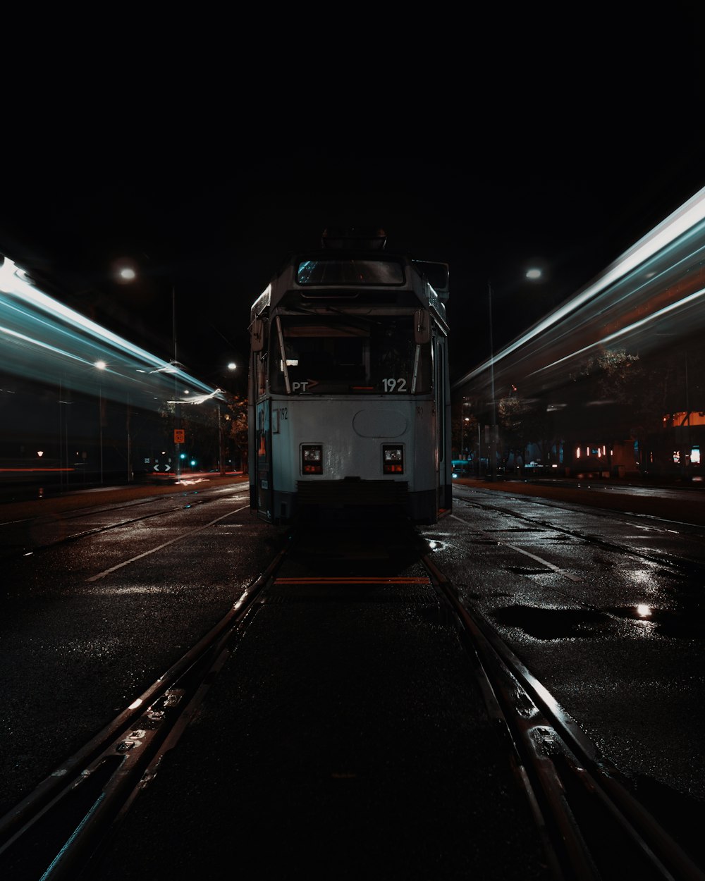 white train on train station during night time