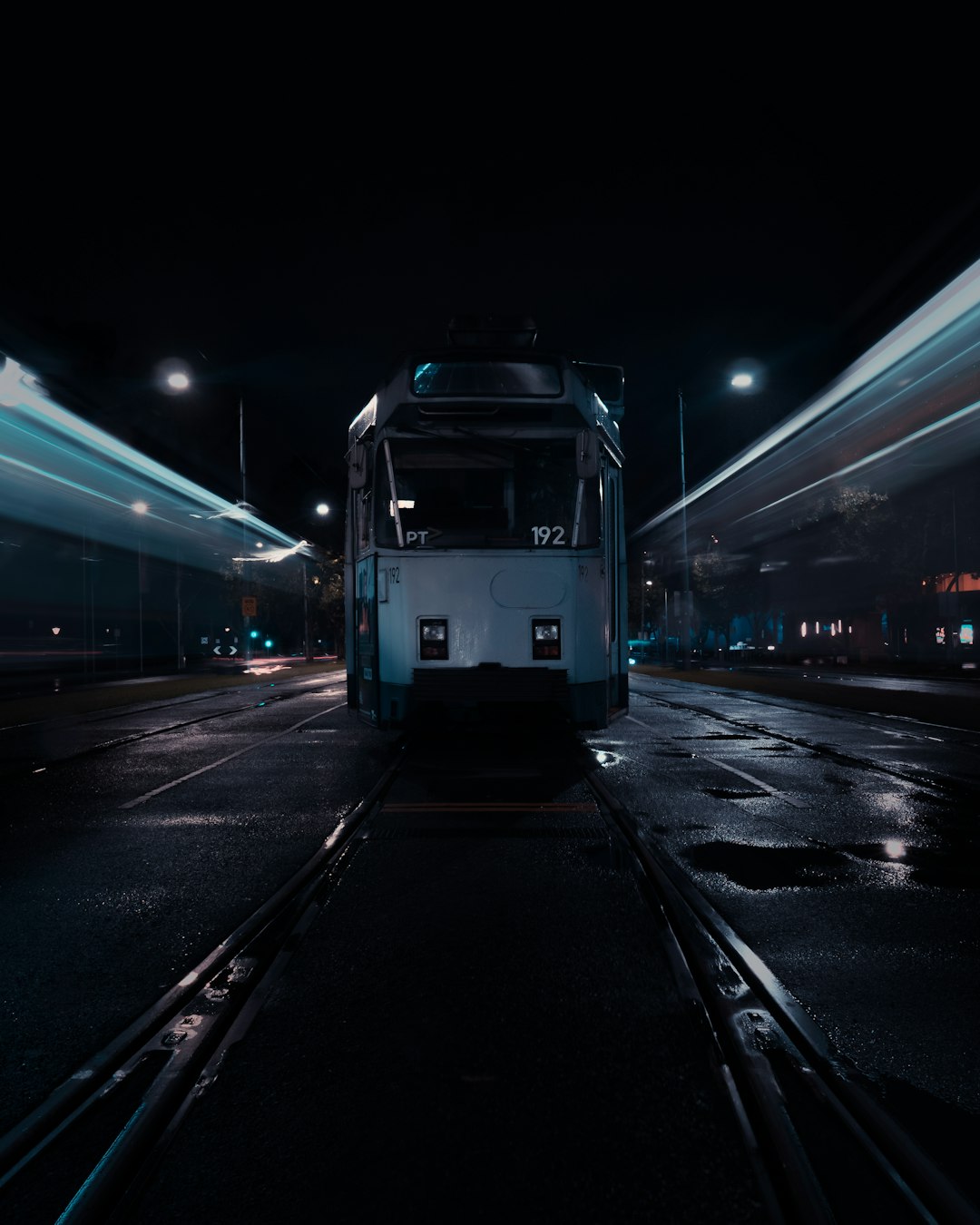 white train on train station during night time