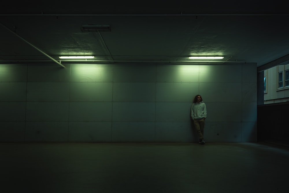 man in gray jacket standing on gray floor tiles