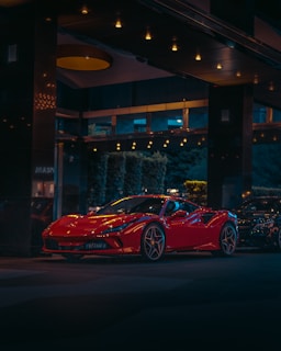 red ferrari 458 italia parked near building