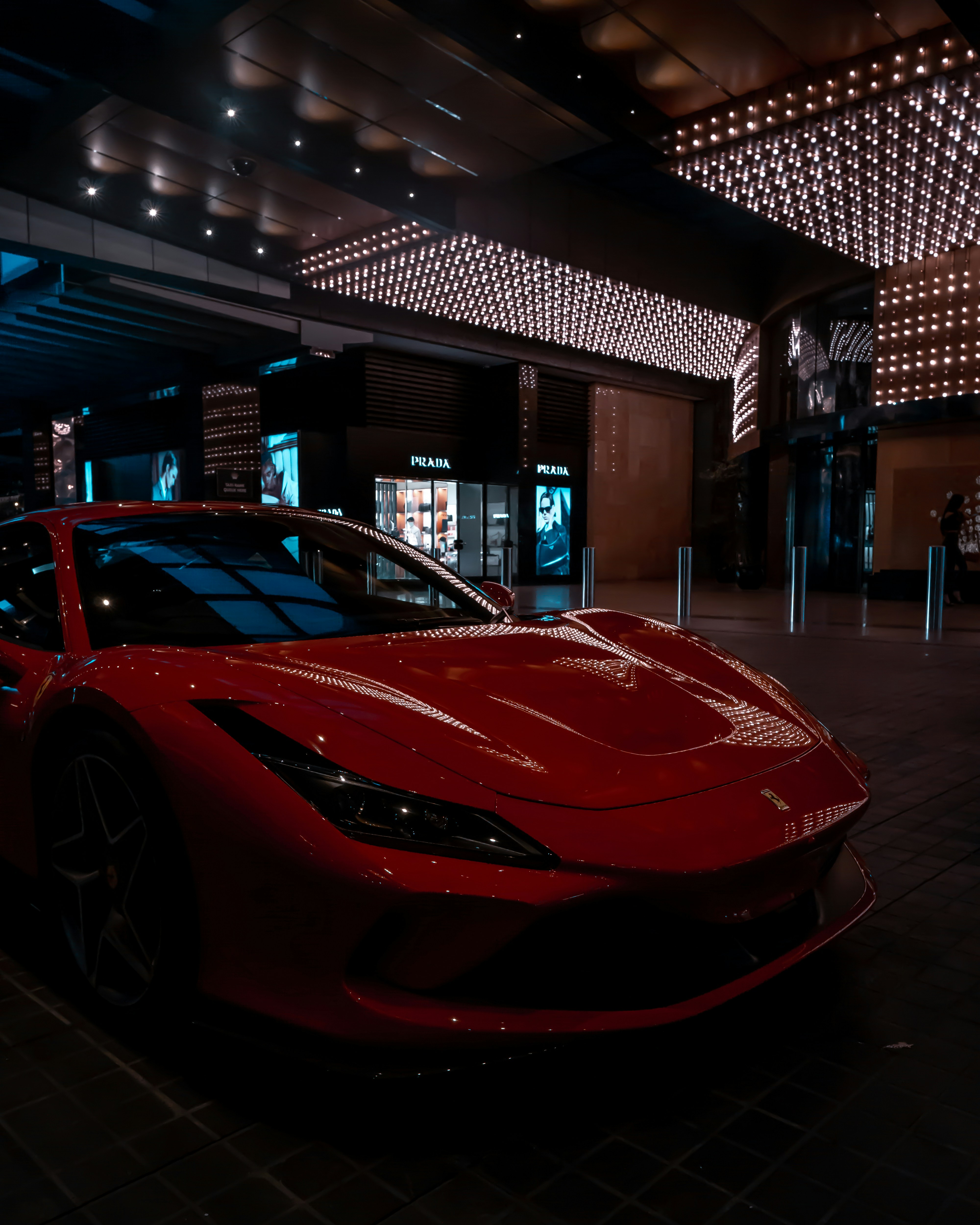 red ferrari 458 italia parked in front of store
