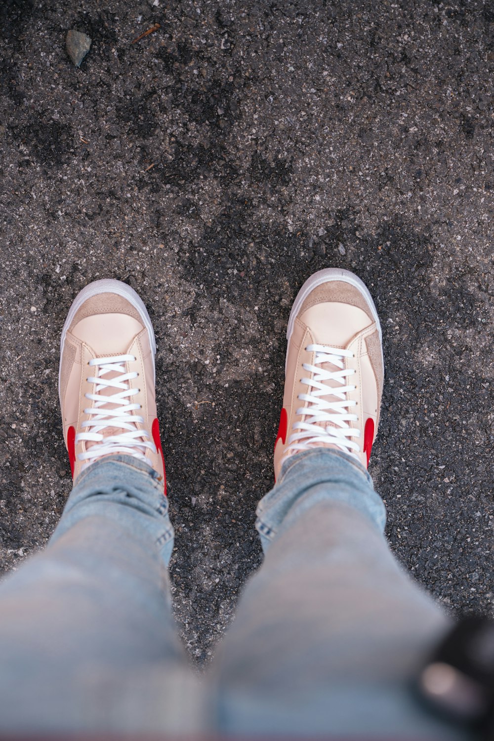 person in blue denim jeans and white sneakers