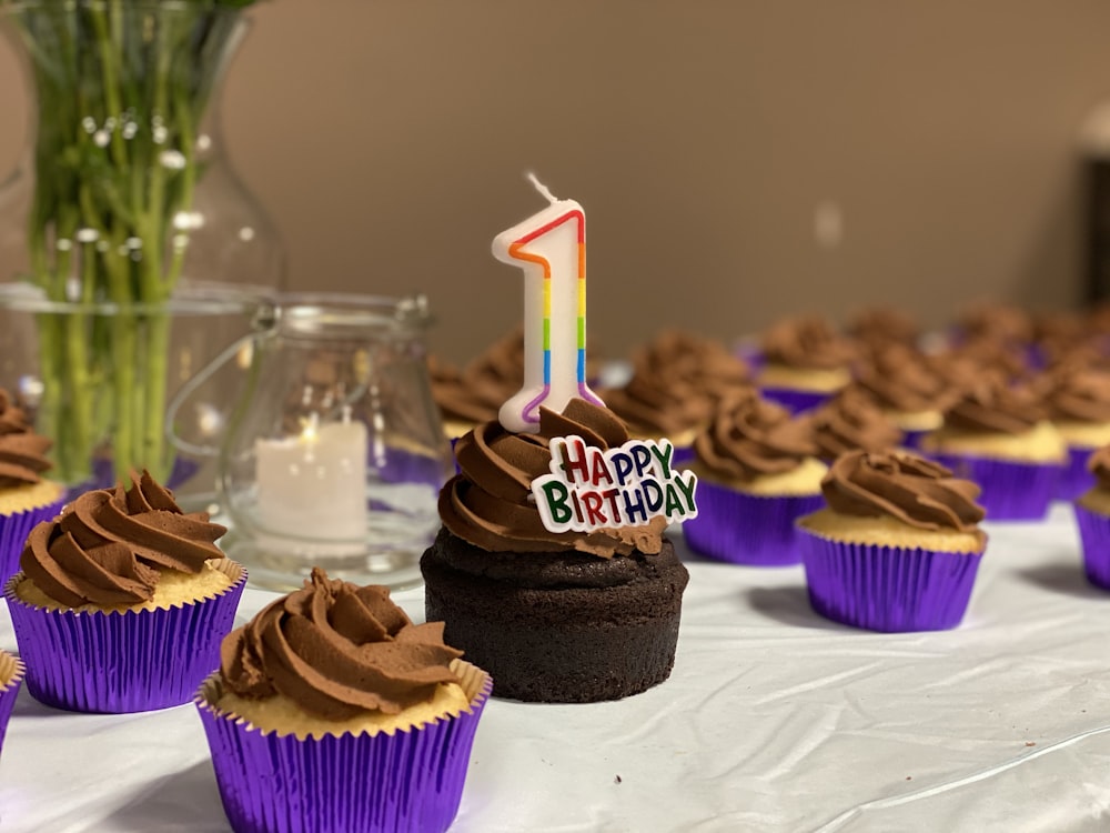 chocolate cupcake with pink and purple candles