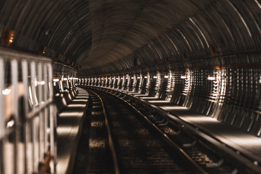 black train rail in tunnel
