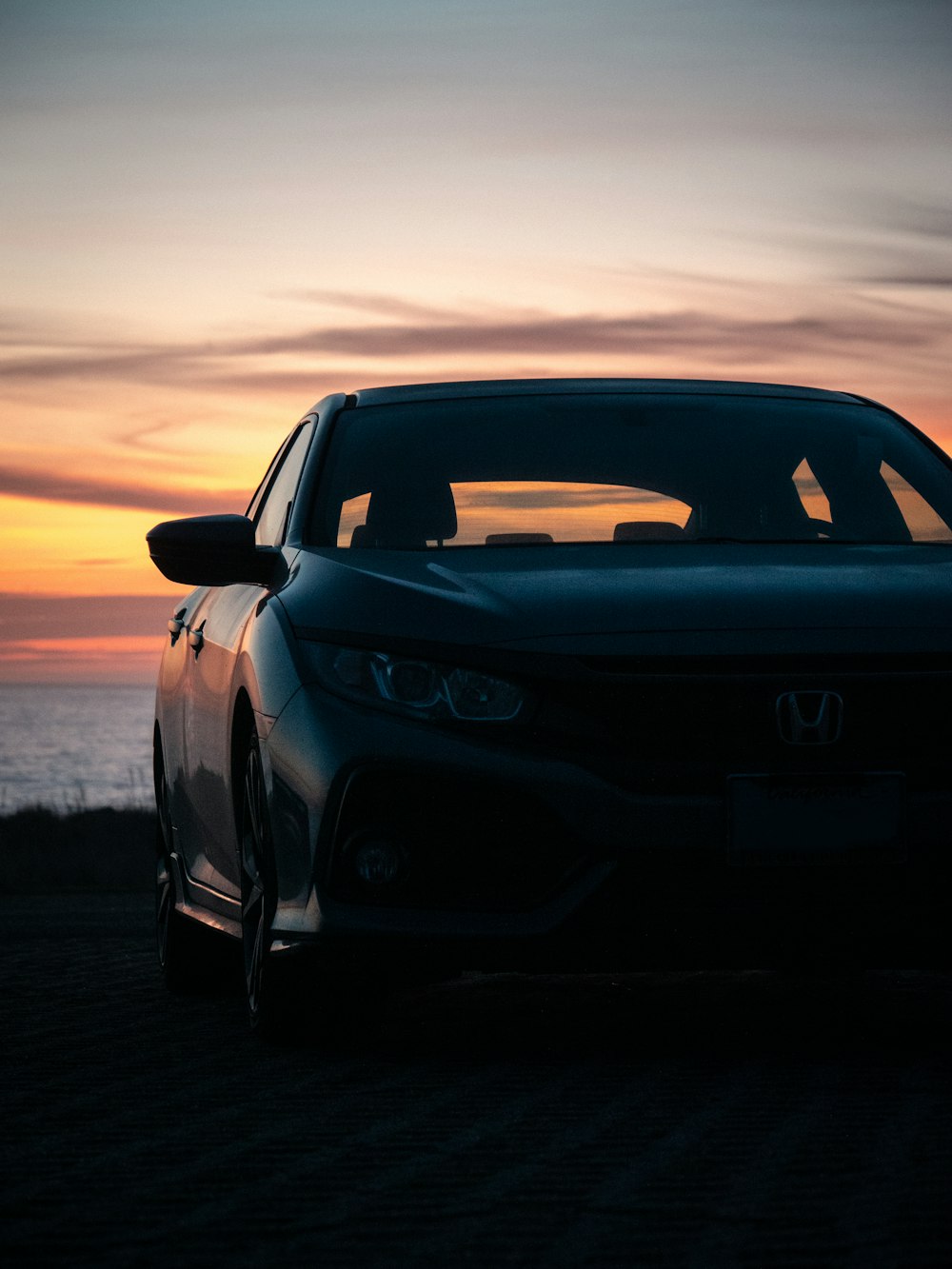 black bmw m 3 on beach shore during sunset