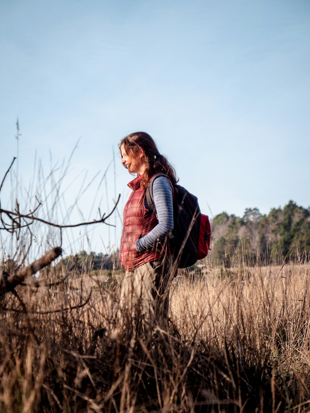 woman in black jacket standing on brown grass field during daytime