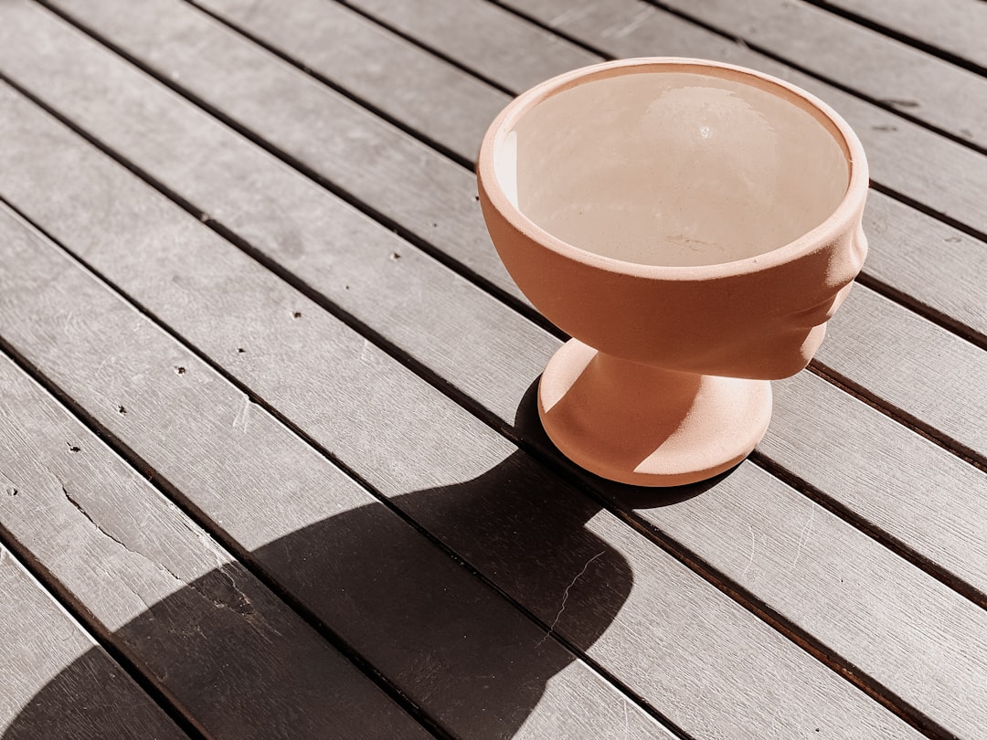 orange ceramic mug on brown wooden table