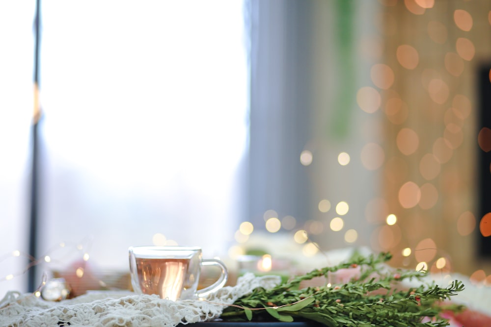 clear glass mug on white table