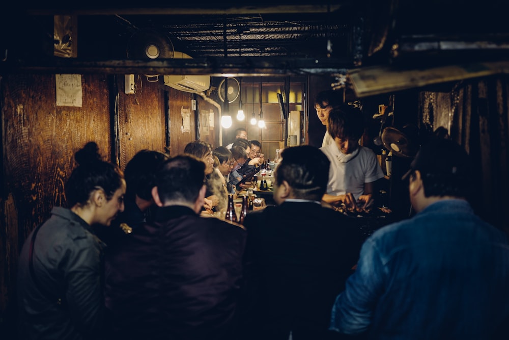 people standing and sitting inside building