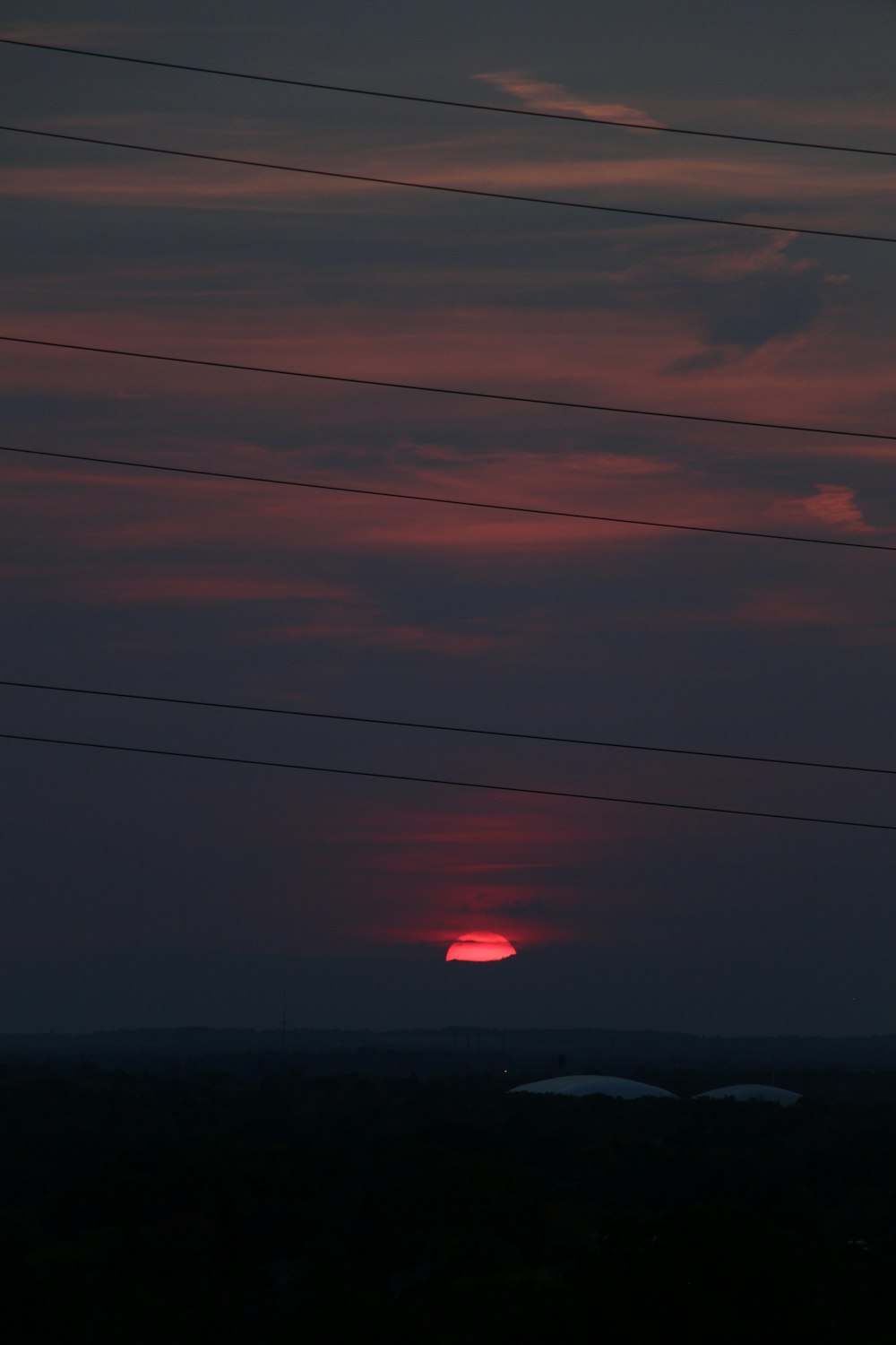 red hot air balloon over the clouds during sunset