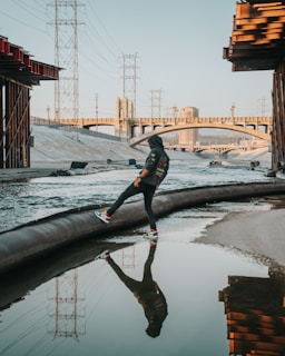 A professional drainage technician inspecting a drainage system in an urban setting.