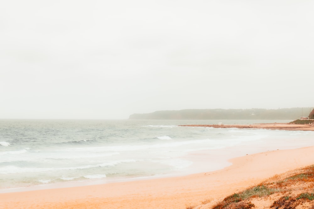 ocean waves crashing on shore during daytime