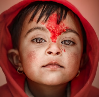 woman in red hoodie with red powder on face